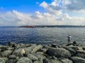 Fisherman fishes in the Sea of Ã¢â¬â¹Ã¢â¬â¹Marmara on the promenade in Istanbul, Turkey. Large boulders on the banks of the Bosphorus, a